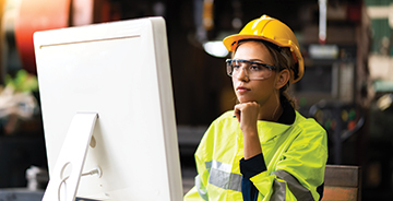 Construction worker sitting at a computer